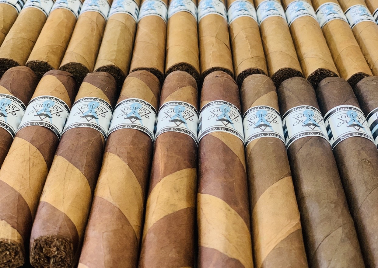 Rows of hand-rolled cigars with custom printed event bands