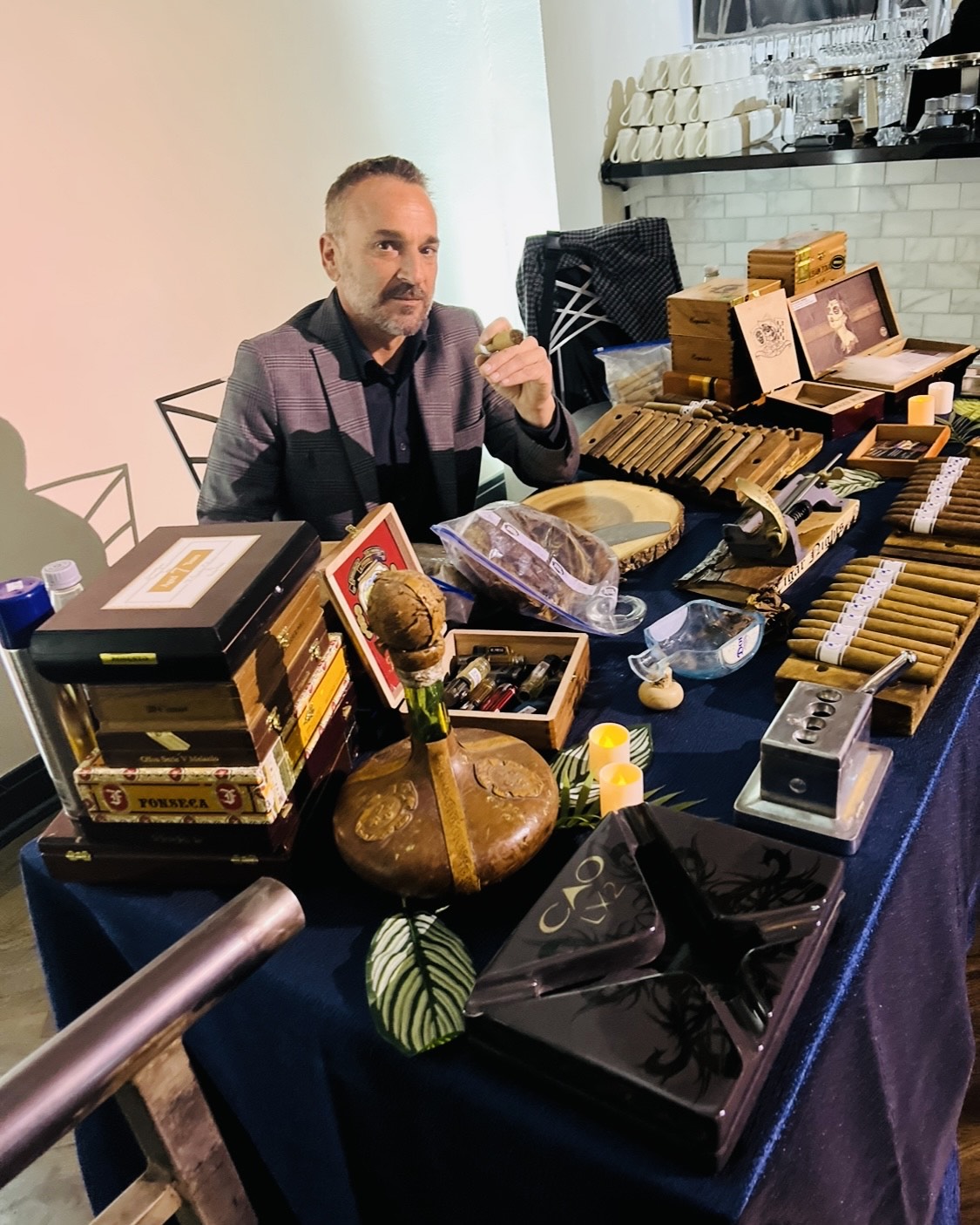 Cigar Nights master roller at a fully dressed cigar table